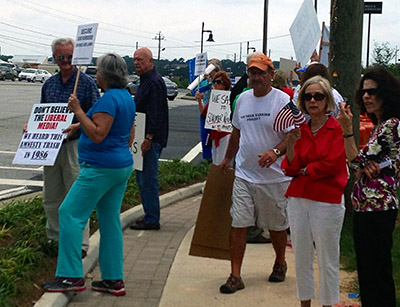 Drivers passing by honked their horns in support